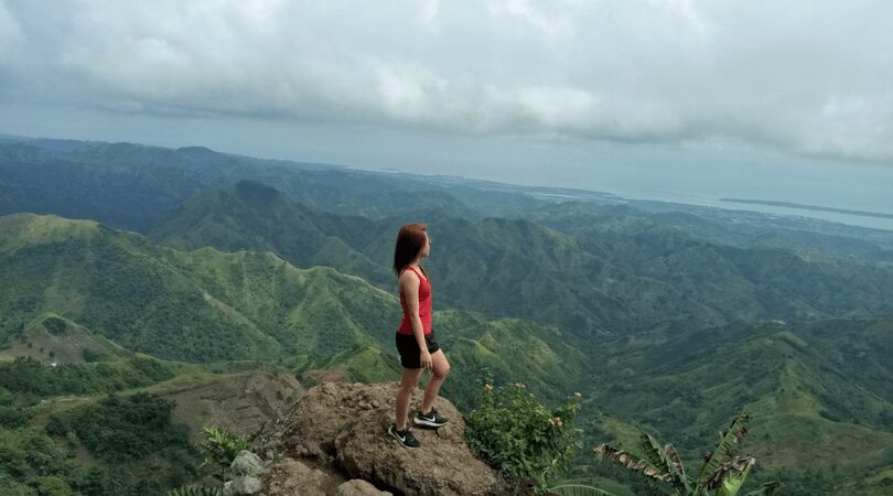 A Filipino girl at the peak of a mountain