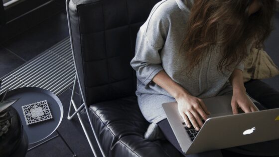 A woman typing something in her laptop