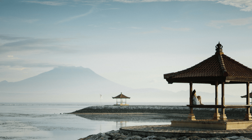 a beach with traditional cottages in Bali, Indonesia