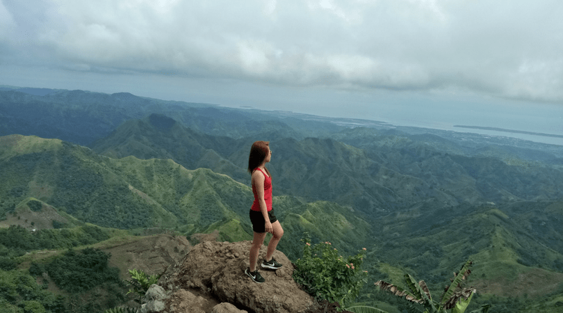 a Filipino girl at the peak of a mountain